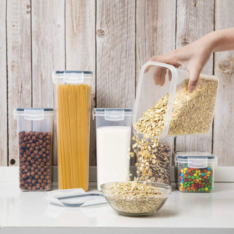 Airtight Food Storage Containers With Lids 7 Piece BPA Free Kitchen Canisters for Spaghetti Pasta Flour Sugar and Dry Goods filled with oats on a kitchen counter.