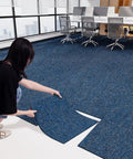Installation of 20 Pack 20x20 Inch Carpet Tiles With Stickers, Reusable, PVC Backed, Slip-Resistant, in a modern office, Blue