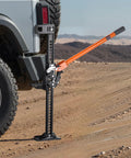 VEVOR 42 Inch Farm Jack 7000 Lbs High Lift Utility Ratchet Off Road Heavy Duty Truck Tractor SUV Jeep Recovery Winch Clamp Pull Tool 5-36 In Range positioned next to a vehicle on rugged terrain.
