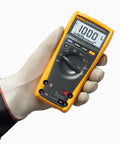 Person holding True-RMS Digital Multimeter Pro Grade Shop-Ready With 6000 Count Scale, Fast 4x Per Second Updates, 33-Segment Bar Graph