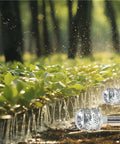 2 Pack Aluminum Bubbler Sprinkler Heads for gentle watering, installed in garden, showing metal construction and water diffusion on plants.