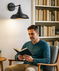 Man reading under Black Vintage Battery Operated Wall Sconce Set Of 2 With Remote Control Cordless Indoor Wall Lamps in living room