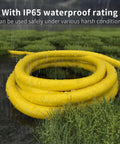 Tough As Nails Heavy Duty Outdoor Extension Cord 100 Ft Waterproof with Lighted End in wet grassy area showcasing waterproof feature