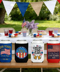 Patriotic 250th Anniversary Can Cooler Sleeves 12 Pack Neoprene Insulated Beverage Holders displayed on a picnic table