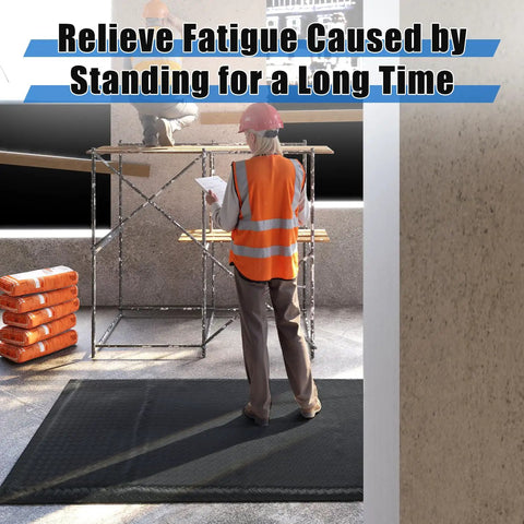 Worker standing on 3 By 7 Foot Anti Fatigue Floor Mat Extra Thick One Inch For Machinist Shop Garage Standing Pad With Anti Static Rubber Top EPDM Foam Core And Conductive Bottom To Reduce Foot And Leg Fatigue Black in construction area.