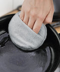 User applying Heavy Duty Five Inch Microfiber Wood Conditioner Applicator Pads For Cutting Board Wax And Oil Spreaders to a pan.