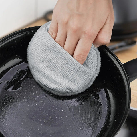 User applying Heavy Duty Five Inch Microfiber Wood Conditioner Applicator Pads For Cutting Board Wax And Oil Spreaders to a pan.