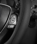 Premium Black Microfiber Leather Steering Wheel Cover For Cars And Trucks covering buttons on a steering wheel, providing a soft grip.