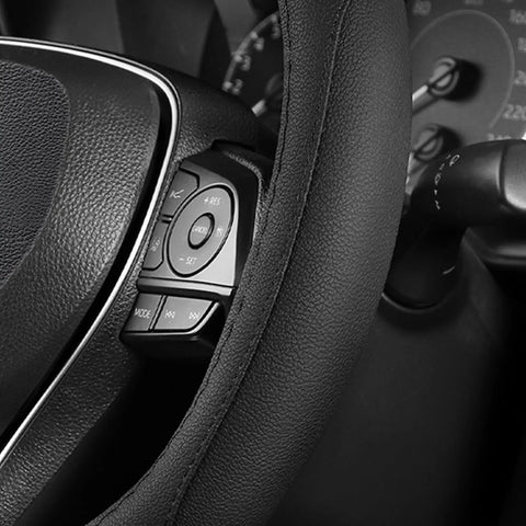 Premium Black Microfiber Leather Steering Wheel Cover For Cars And Trucks covering buttons on a steering wheel, providing a soft grip.