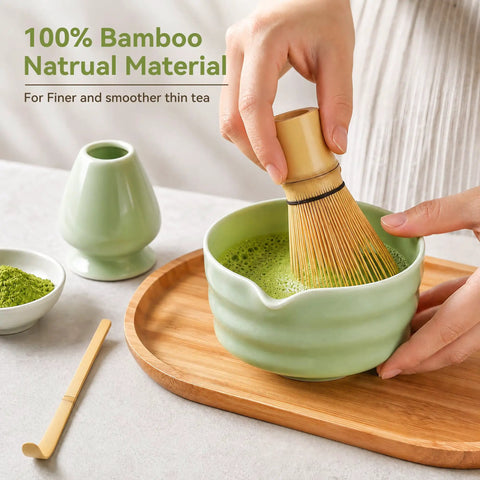 Complete Five Piece Matcha Making Kit With Bamboo Whisk Chasen stirring matcha in ceramic bowl on bamboo tray