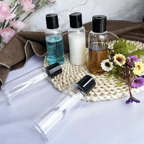 5 Pack 3.4 Oz Travel Bottles With Labels Leakproof Plastic Containers TSA Approved Travel Size Empty Bottles Set on a woven mat with flowers
