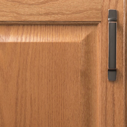 Solid Core Cabinet Pulls for Kitchen and Dresser Doors Richmond Collection Oil Rubbed Bronze Highlighted Bar Pulls With Three Inch Center To Center Four And Nine Sixteenths Inches Long Luxury Hardware For Contemporary And Traditional Includes Mounting shown on wood cabinet door.