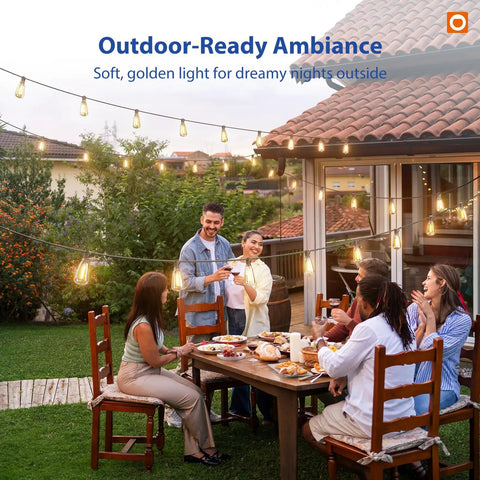 100 Ft LED Outdoor String Lights With Remote Control hanging above a backyard dinner party, creating a cozy ambiance.