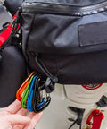 12kN Aluminum D Ring Carabiner Clips Wiregate Green Pack Of 4 attached to a black backpack