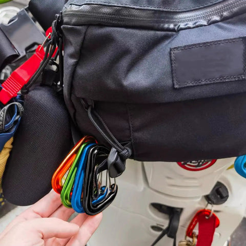 12kN Aluminum D Ring Carabiner Clips Wiregate Green Pack Of 4 attached to a black backpack