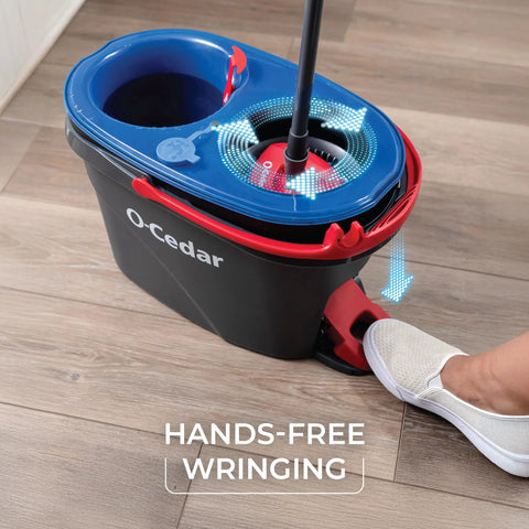 Close-up of RinseClean Spin Mop And Bucket System For Clean Water Mopping Lets You Clean With Clean Water From Start To Finish Removes 99 Percent Of Bacteria With Just Water Built In Foot Pedal For Hands Free Wringer And Easy Rinse showing the foot pedal in use on wooden floor.