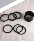 Eight Piece Aluminum Bike Headset Spacers Set For One And One Eighth Inch Stems With 2mm 3mm 5mm And 10mm Spacers on wood surface