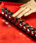 Gloved hand arranging Three Eighth Inch Drive Weatherhead Socket Master Set 13 Piece SAE Sockets on a plastic rail