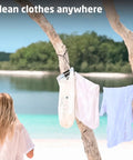Hassle Free Portable Laundry Bag With Built In Flexible Washboard Design For Fast Machine Quality Clothing Refreshes While Outdoors Cruising Or RV Road Trips A Total Lifesaver, hanging laundry on tree by beach.