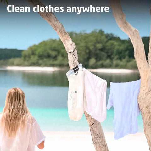 Hassle Free Portable Laundry Bag With Built In Flexible Washboard Design For Fast Machine Quality Clothing Refreshes While Outdoors Cruising Or RV Road Trips A Total Lifesaver, hanging laundry on tree by beach.