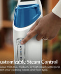 Heavy Duty Steam Mop With 12 Inch Sweeping Path For Hardwood And Tile Floors Featuring Built In Scrubber And Variable Steam Controls being adjusted.
