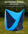 Ultra Portable Hammock Chair For Indoor And Outdoor Use Great For Chill Time Go Anywhere Hanging Swing Made From Lightweight Nylon Parachute, showcasing rust-proof rods and waterproof material in navy blue, set up outdoors on grass.