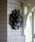Metallic flower sculpture on a shingled wall near an archway, outdoors, with Extreme Interlocking Fasteners 4 Strips 1x3 Inches for mounting.