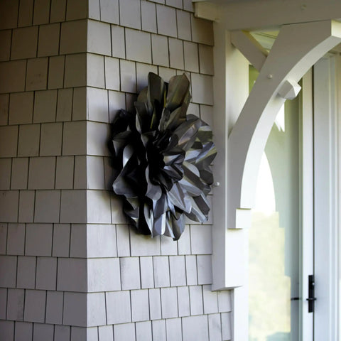 Metallic flower sculpture on a shingled wall near an archway, outdoors, with Extreme Interlocking Fasteners 4 Strips 1x3 Inches for mounting.