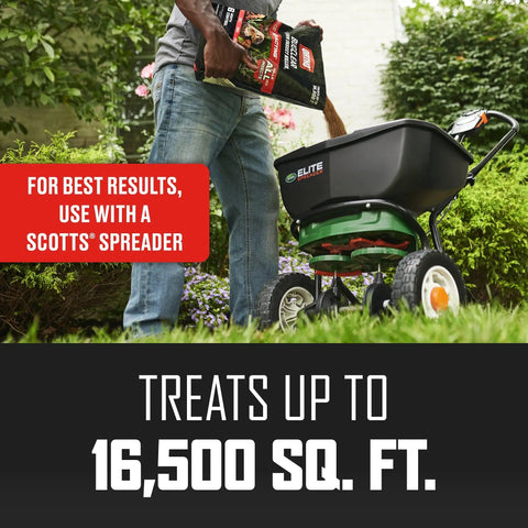 Person using Long Lasting Lawn Insect Killer Granules Kills Ants Spiders Ticks Fleas And Grubs Quick Acting Bug Barrier Treats Up To 16500 Sq Ft With A 10 Lb Bag Providing Months Of Protection with Scotts spreader.