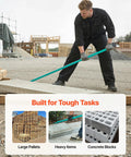 Man using Monster Pry Bar With 52.5 Inch Carbon Steel Handle For Demolition And Concrete Teardown Heavy Duty Crowbar 2000lbs Prying Capacity Floor Demo Tool Ideal For Construction And Industrial Use on a construction site.