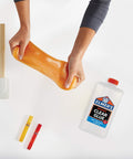 Hands stretching slime with Elmer's Clear Liquid School Glue for Arts and Crafts, Go To Washable and Non Toxic, 32 Ounces Bottle