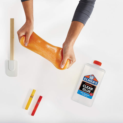 Hands stretching slime with Elmer's Clear Liquid School Glue for Arts and Crafts, Go To Washable and Non Toxic, 32 Ounces Bottle