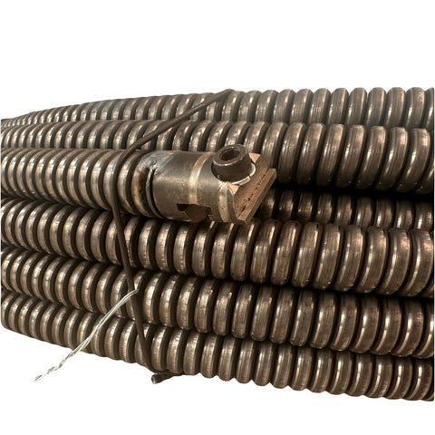 Badass 11 16 Inch By 120 Foot Hollow Core Drain Cleaning Cable With Opposite Wound Inner Core coiled for easy use in drain cleaning.