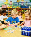 Children using All Purpose Office Glue Sticks 6g Pack Of 30 Purple Goes On Dries Clear for paper and art projects.