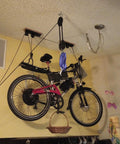 Rope Hoist Pulley System 1000 Lb Capacity 5 To 1 Block And Tackle with 50ft, lifting a bicycle indoors