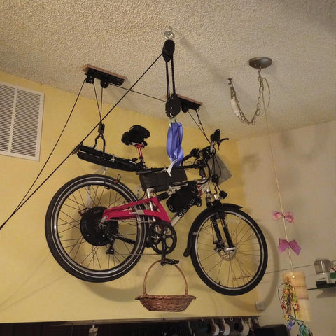 Rope Hoist Pulley System 1000 Lb Capacity 5 To 1 Block And Tackle with 50ft, lifting a bicycle indoors