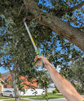 Person using 32 Inch Pole Pruner With Long Reach No Ladder Required For Safe Pruning One Hand Use Snip Grip Technology on tree branch