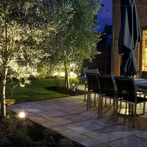 Outdoor garden at night with pathway lighting using 12-Pack Low Voltage Landscape Wire Connectors for Outdoors, Easy Lock-In Fasteners.