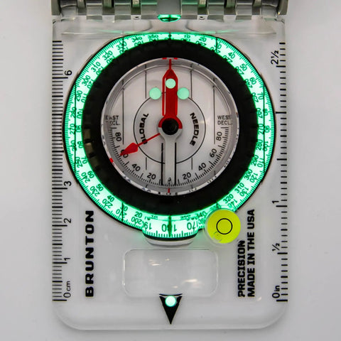 TruArc 20 Luminous Expedition Compass With Glow In The Dark Sighting Tool And Protective Boot Global Needle And Clinometer For Night Navigation And Rescue Ops showing illuminated dial and markings.