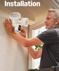 Person installing Floodlight Pro Security Camera With Retinal 2K Video Color Night Vision Two Way Talk And Audio 3D Motion Detection Built In 110 dB Siren Perfect For Home Or Biz Outdoor Security on exterior wall.