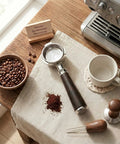 54mm Bottomless Espresso Portafilter With Three Ear Design For Breville And Sage Barista Machines on a countertop with accessories