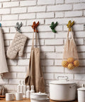 Set Of Six Slick Flying Bird Cast Iron Wall Hooks Featuring Hella Distressed Rustic Finish Decorative Mounted Hanging Hardware Perfect For Home Entryway Upgrades And Cozy Vintage Vibes, displayed with kitchen items.