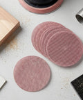 Super Cool 5 inch Mesh Sanding Discs With Hook And Loop Backing, 240 Grit Fine Aluminum Oxide For Wood and Metal Project Dust Free Set of 50 stacked on a work surface.