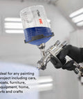 Person using All-In-One PPS 2.0 Spray Cup System Kit with 22 ounce reusable paint cup in automotive paint booth.