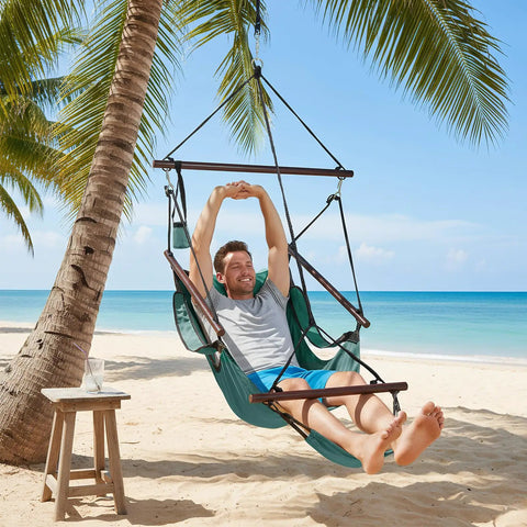 Man relaxing on Upgraded Unique Hammock Hanging Sky Chair With Easy Setup Safer Design Air Deluxe Swing Seat on beach.