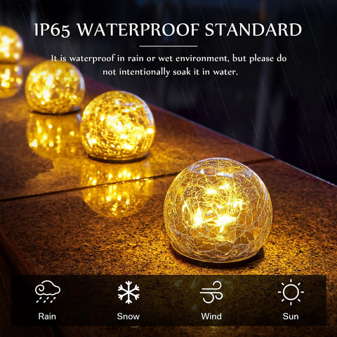 Solar Globe Lights 6 Inch Outdoor Crackled Glass Orbs glowing warmly on a patio, showcasing waterproof design.
