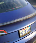 Real Molded Carbon Fiber Matte Dry Look Spoiler For Tesla Model 3 installed on blue car, showcasing aerodynamic design and sleek style.