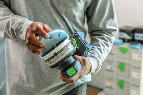 Person using Granat Profile Fine 5 Inch 125 mm Sanding Discs 10 Pack on a power tool for contours and curved surfaces.