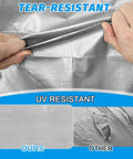 Hands demonstrating Heavy Duty 16 Mil Waterproof Tarp 10x10 Feet for Outdoor Use, showing tear resistance and durability.