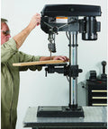 Man using 13 In Benchtop Drill Press With 3/4 HP 120V 5/8 In Chuck 1 In Drilling Capacity 16 Speeds From 220 To 3,300 RPM